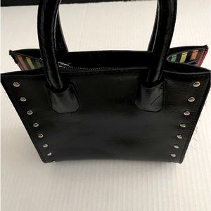 Black and rainbow stripes on the side of the bag, very small bag, good condition